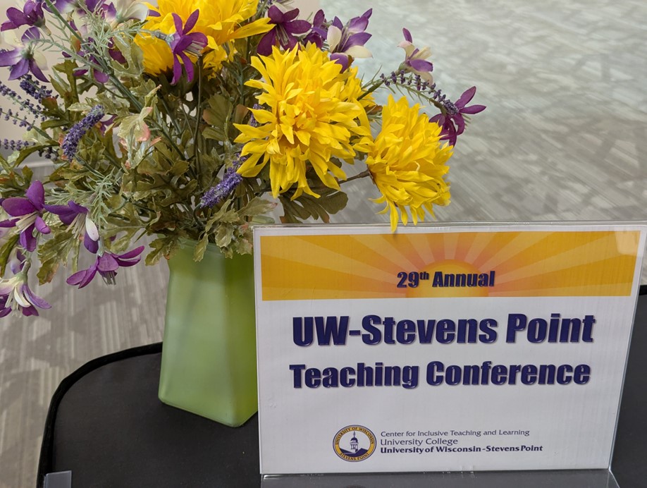 conference table sign with vase of flowers