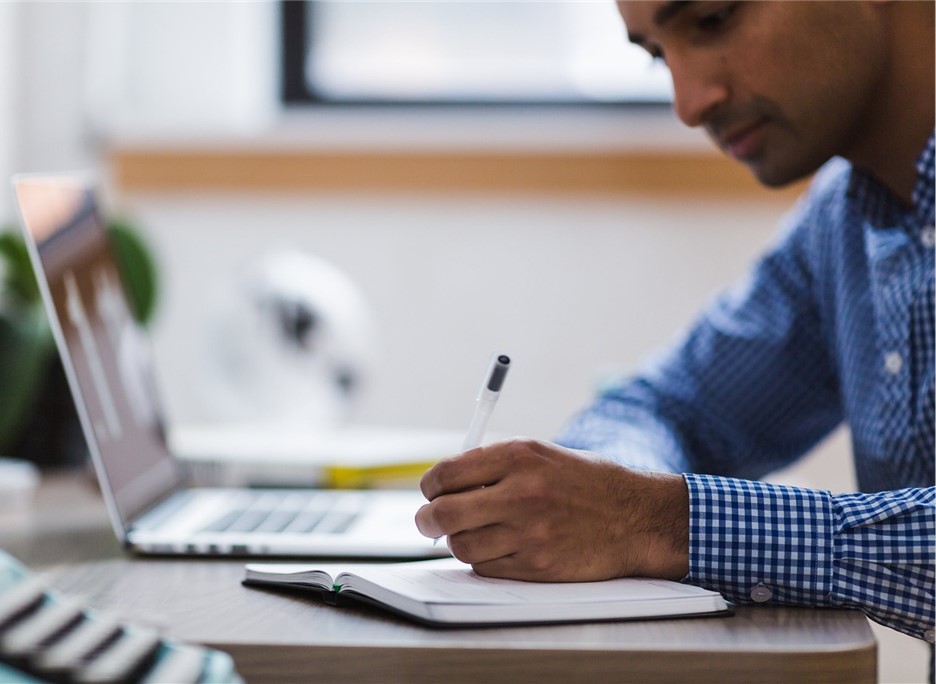 faculty member working at laptop